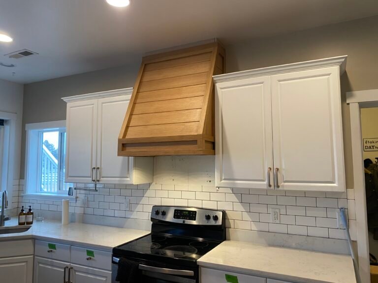 Improvements: Custom white oak range hood casing with natural finish